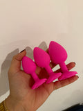 Pink silicone anal plugs set held in hand beginner friendly sex toys Lebanon